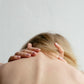 woman applies CBD Balm to her back