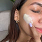 Woman applying antioxidant cream, CBD moisturiser on her face